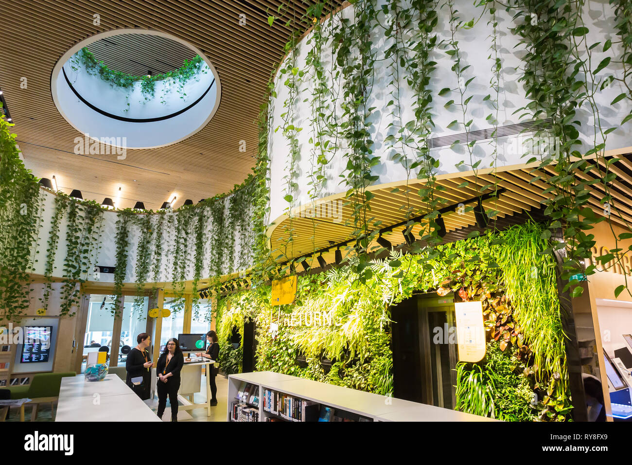 Woollahra library is totally unique in that it is surrounded by greenery inside. The entrance has a vertical garden wall where books can be returned.T Stock Photo