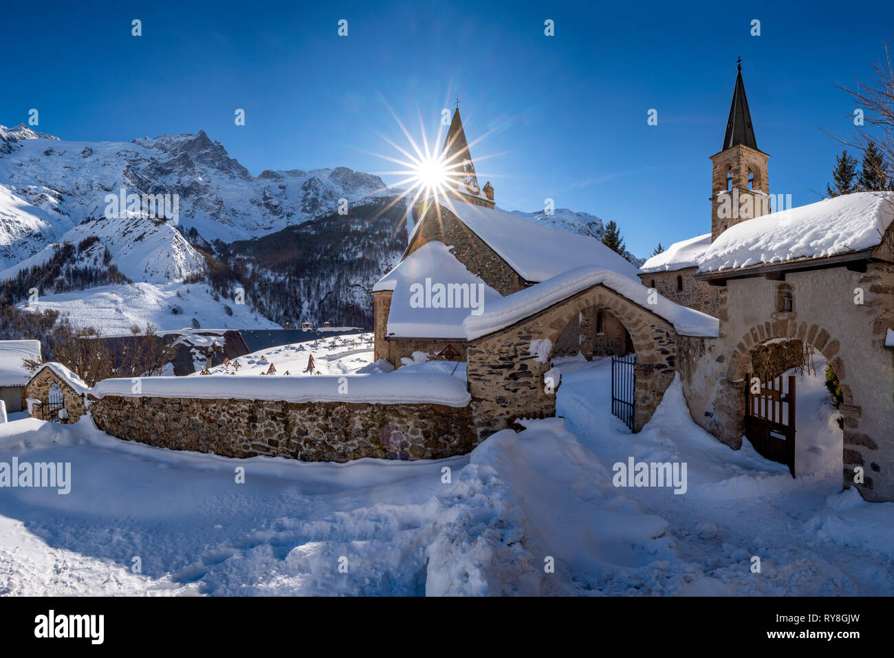 La Grave, Hautes-Alpes, Ecrins National Park, Alps, France: The local village of La Grave and its church with La Meije mountain peak in winter Stock Photo