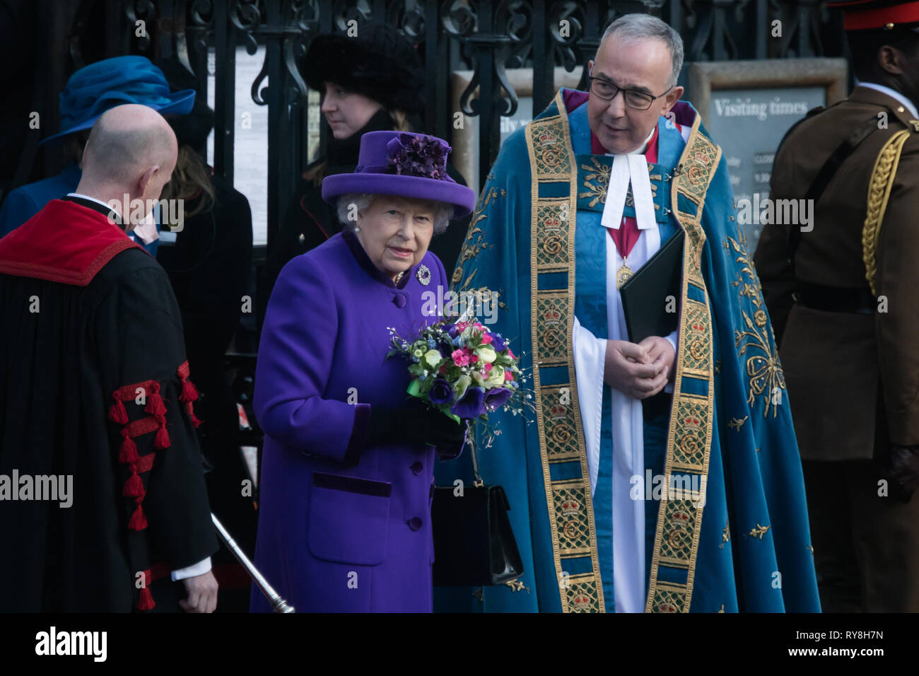 Her Majesty, Queen Elizabeth II stands alongside John Hall, Dean of Westminster following a service for Commonwealth Day at Westminster Abbey Stock Photo