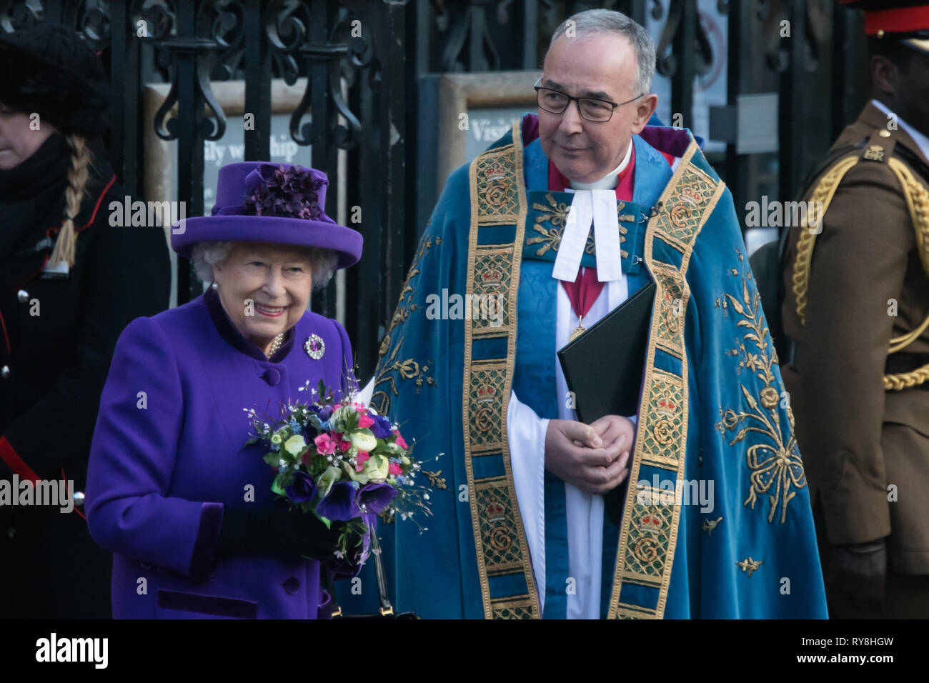 Her Majesty, Queen Elizabeth II stands alongside John Hall, Dean of Westminster following a service for Commonwealth Day at Westminster Abbey Stock Photo