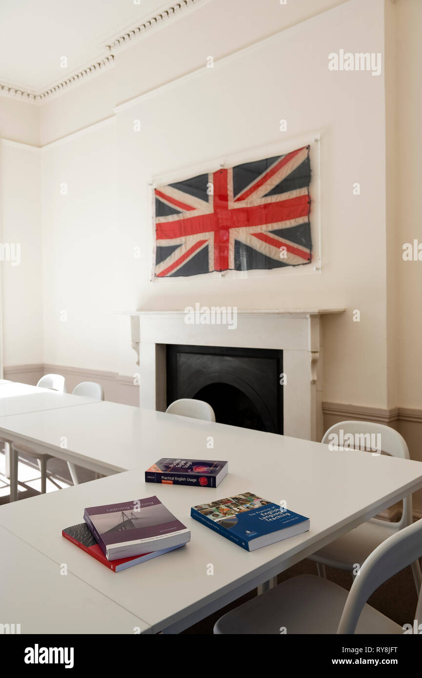 'Union Jack over fireplace in classroom at TEFL Lab in London, England' Stock Photo