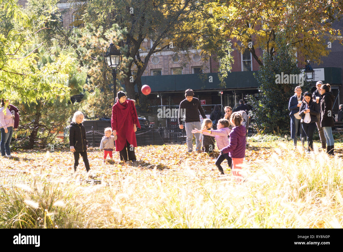 People Enjoying a Sunny Fall Day in Washington Square Park, NYC Stock Photo