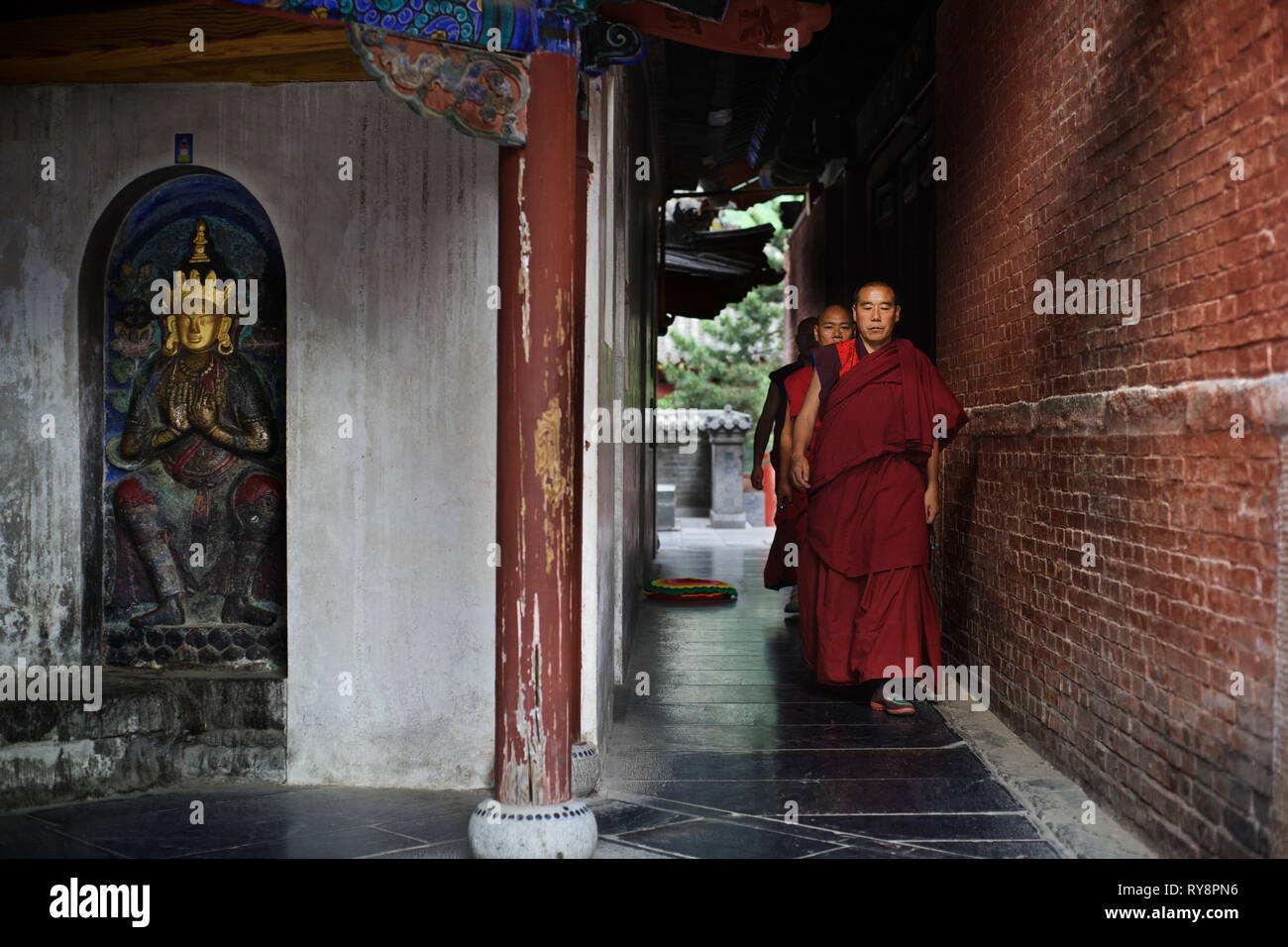 Chinese monks walking around stupa, Wutai Shan, Shanxi, China Stock Photo