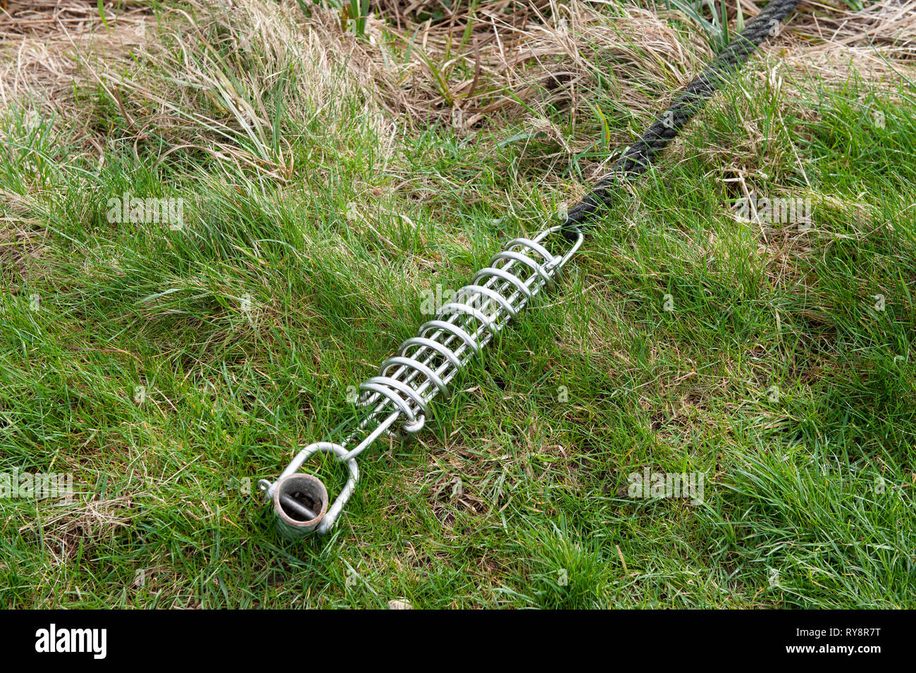 A galvanised steel spring 'snubber' mooring a narrowboat on the Kennet ...
