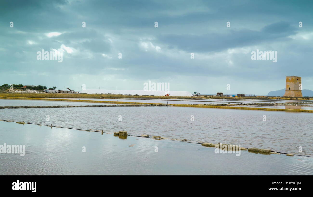 The big wide empty fields in the saltmine area filled with water in Trapani Sicily in Italy Stock Photo