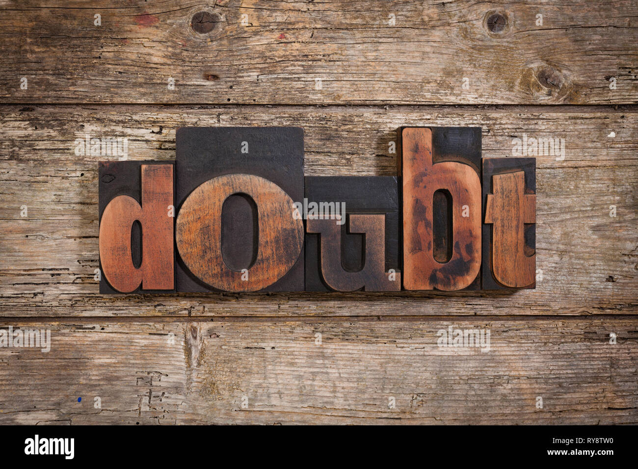 doubt, single word set with vintage letterpress printing blocks on rustic wooden background Stock Photo