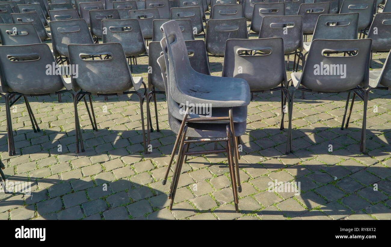 Three chairs on top of each other in Vatican Rome Italy for people to hear the mass in the church Stock Photo