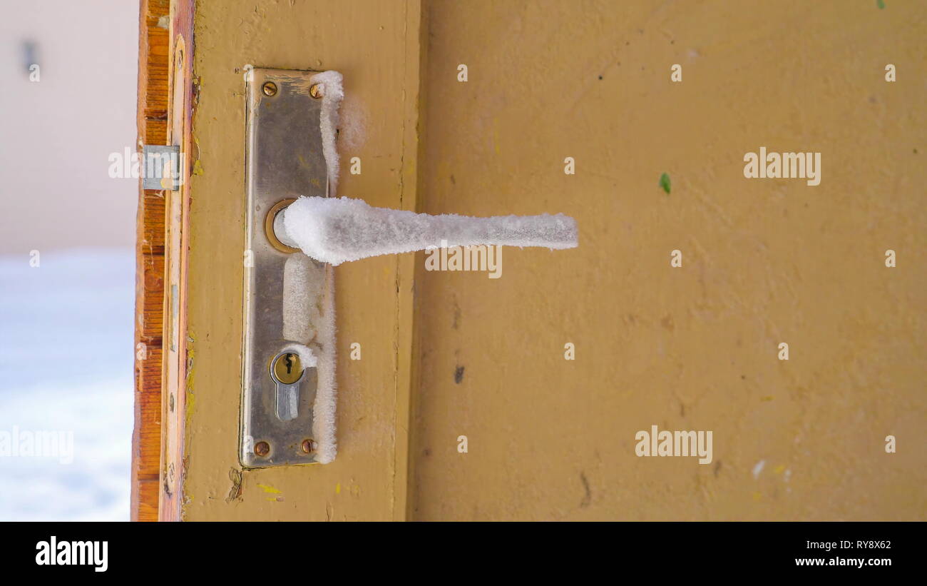 Closer Look Of The Door Knob Covered With Ice From A Broken Door