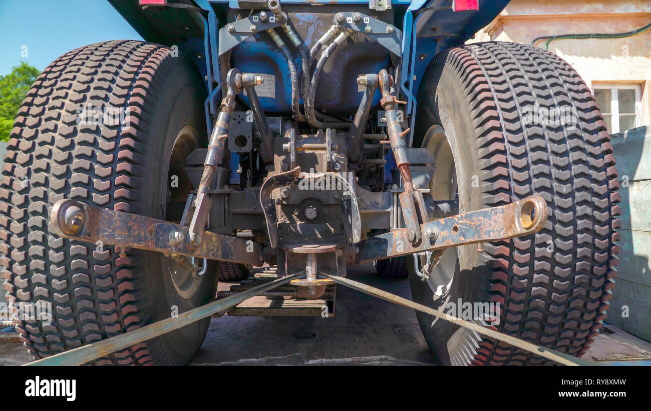 Two big tires of a small car truck on top of the truck inside it to be