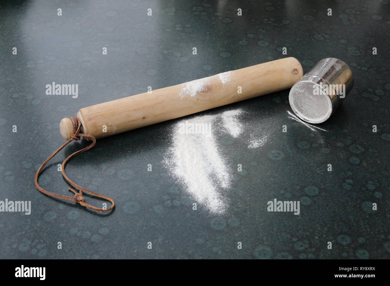 Wooden rolling pin, flour and flour shaker on a kitchen worktop Stock Photo Alamy