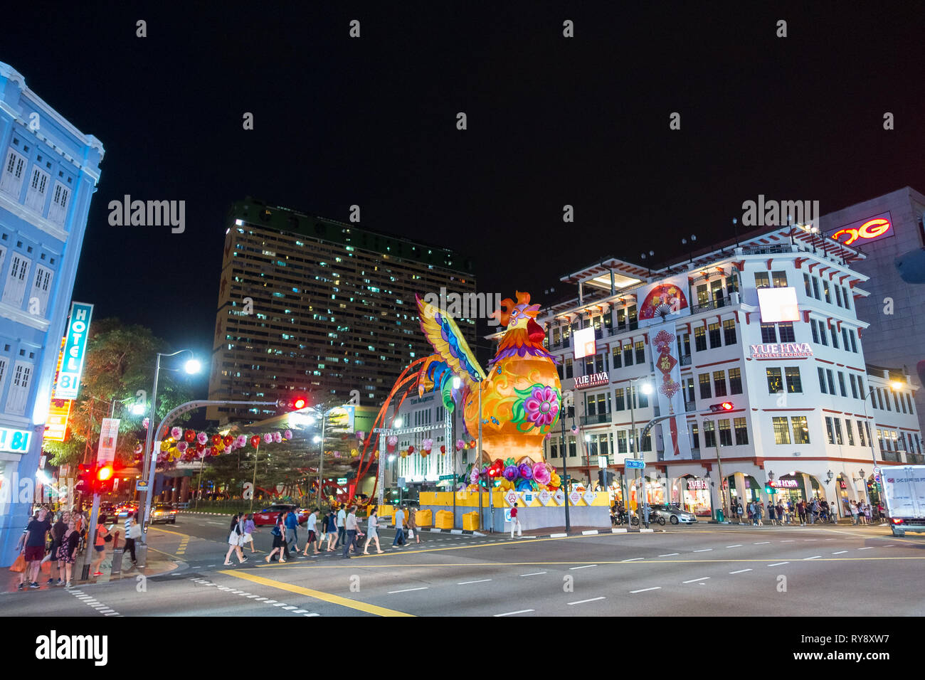 Pedestrians in crosswalk on Cross Street, With Giant Rooster Lantern -  Chinatown, Singapore Stock Photo