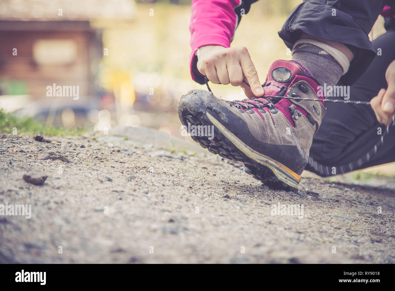 Close up of hiking boots, woman is tying them to prepare for wander Stock Photo
