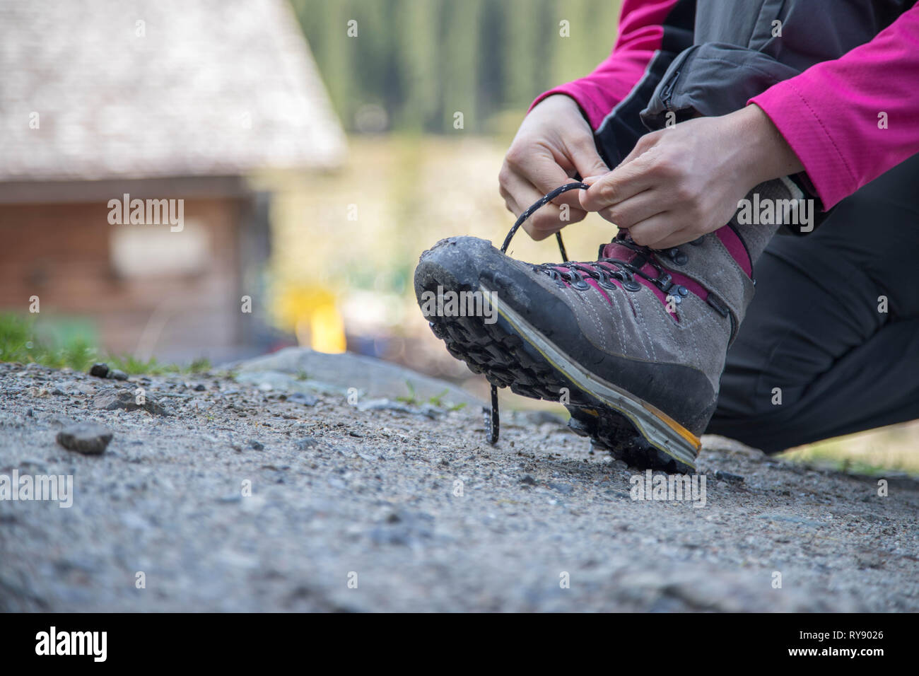 Close up of hiking boots, woman is tying them to prepare for wander Stock Photo