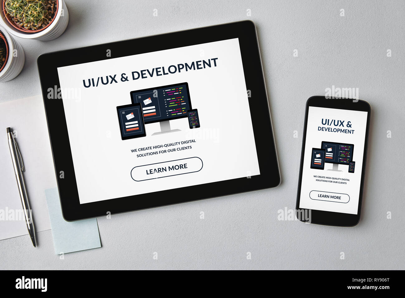 UI/UX design and development concept on tablet and smartphone screen over gray table. All screen content is designed by me. Flat lay Stock Photo