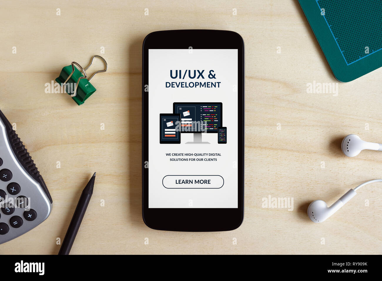 UI/UX design and development concept on smart phone screen on wooden ...