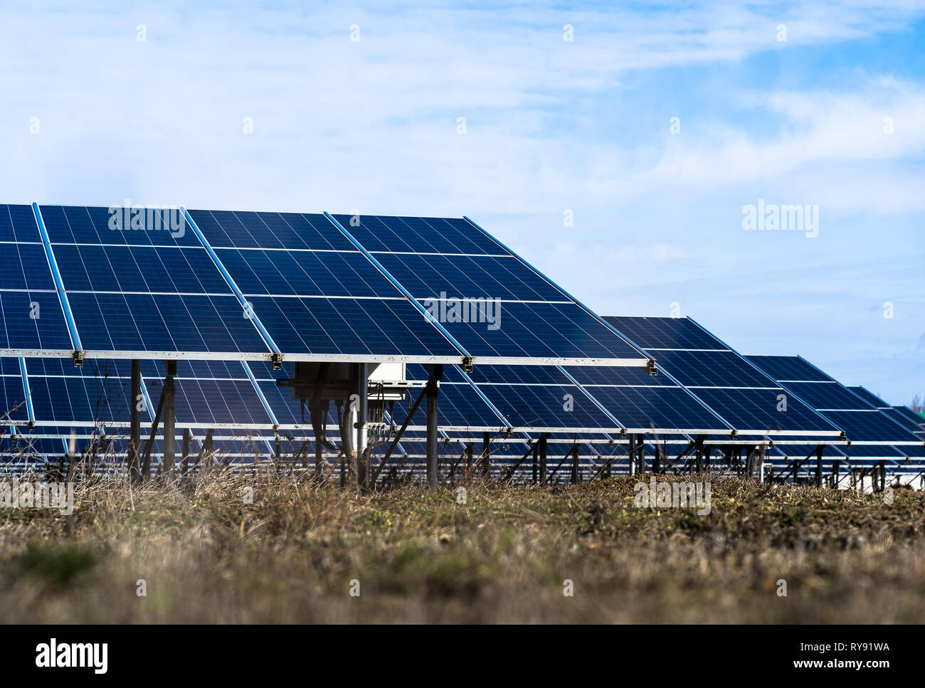 Solar cells in a row, blue sky background. Photovoltaic supply Stock Photo