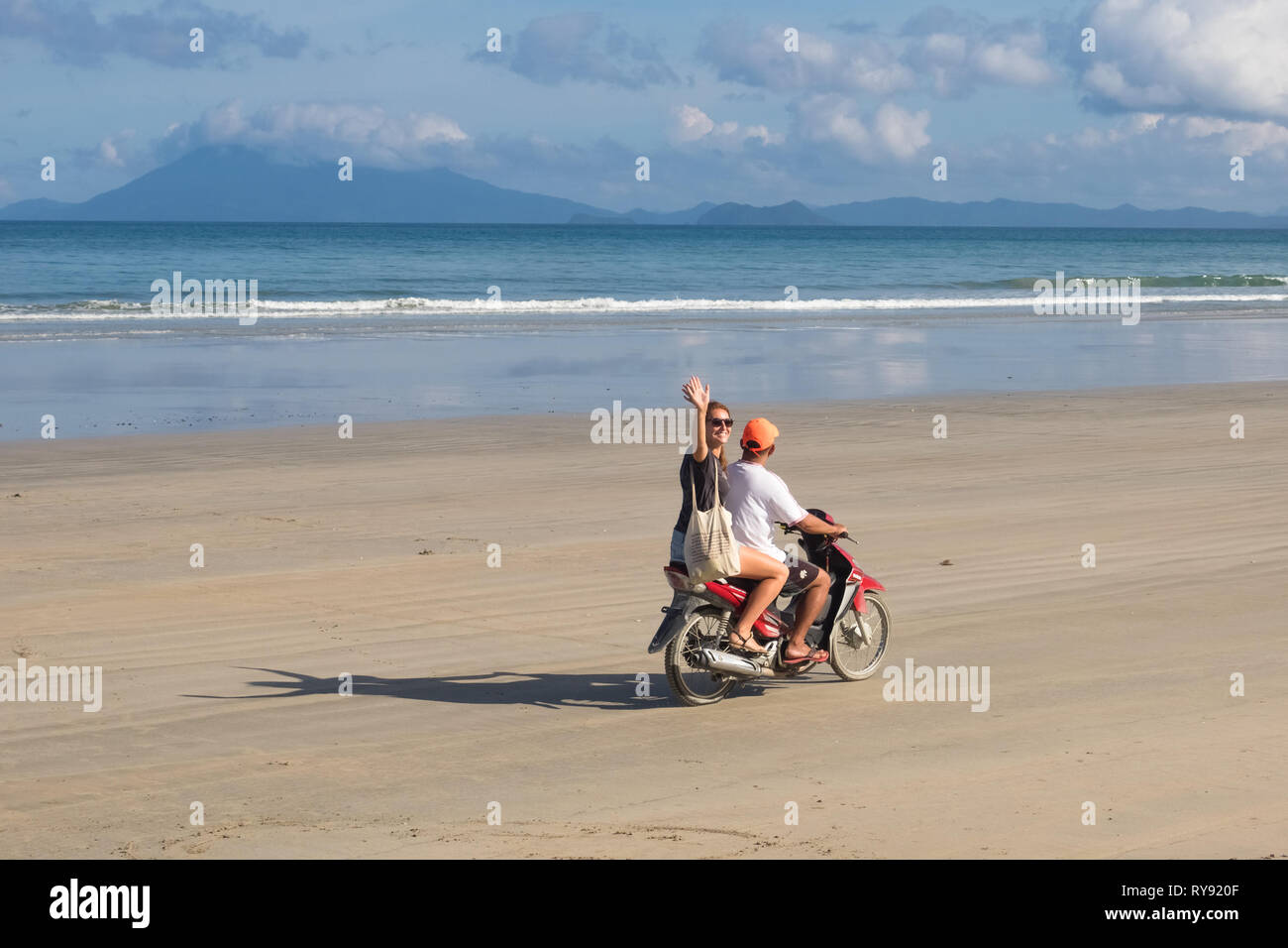 British tourist waving from back of taxi motorbike - San Vicente Long Beach, Palawan - Philippines Stock Photo