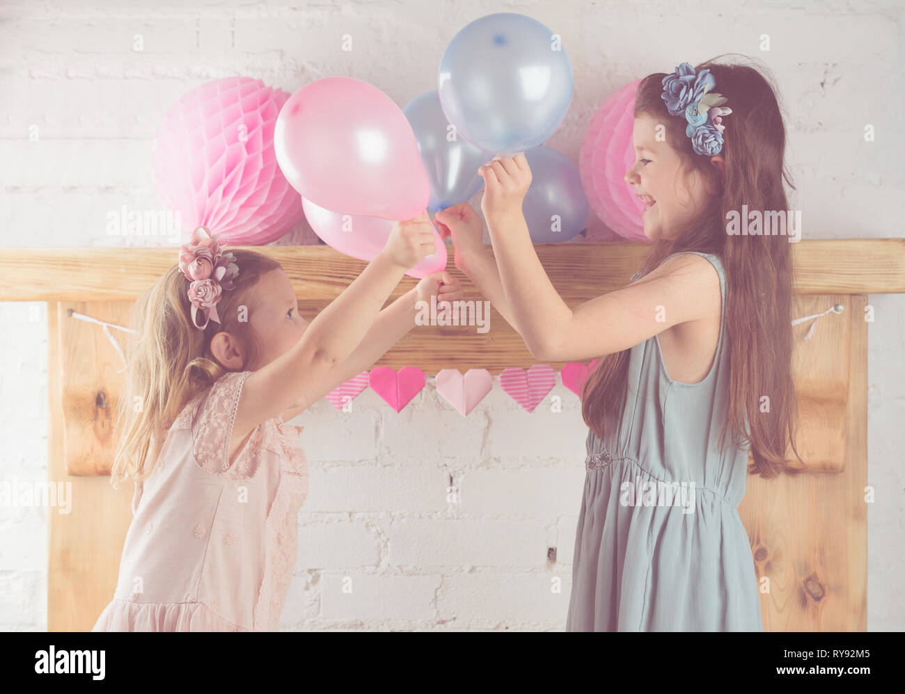 Two Little Girls In Pastel Pink And Blue Dresses Floral Headbands Holding Pastel Colored Balloons Solid Wood Mantelpiece Background Toned Selective Focus Stock Photo Alamy Two Little Girls In Pastel Pink And Blue Dresses Floral Headbands Holding Pastel Colored Balloons Solid Wood Mantelpiece Background Toned Selective Focus Stock Photo Alamy