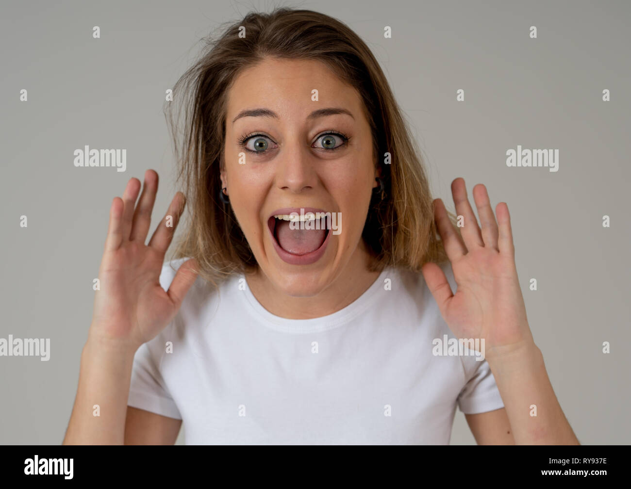 Portrait of beautiful shocked woman winning the lottery or having great success with surprised and happy face and gestures in Facial Expression, Human Stock Photo
