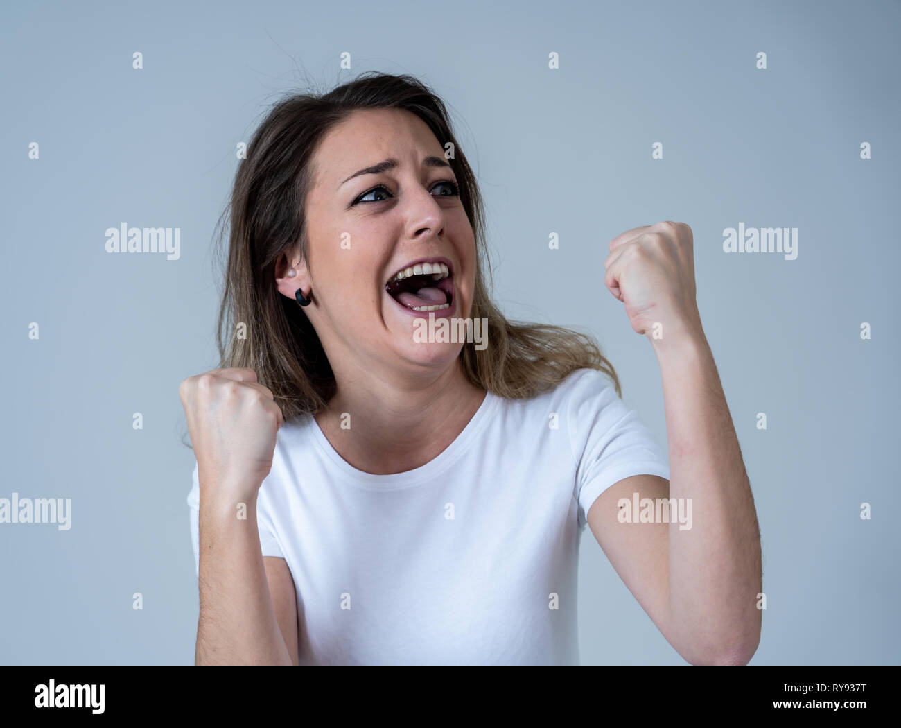 Portrait of beautiful shocked woman winning the lottery or having great success with surprised and happy face and gestures in Facial Expression, Human Stock Photo