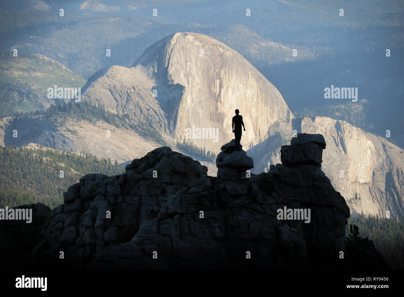 Rock Climber Man Silhouette With Half Dome Afternoon Light - Yosemite National Park, California Stock Photo