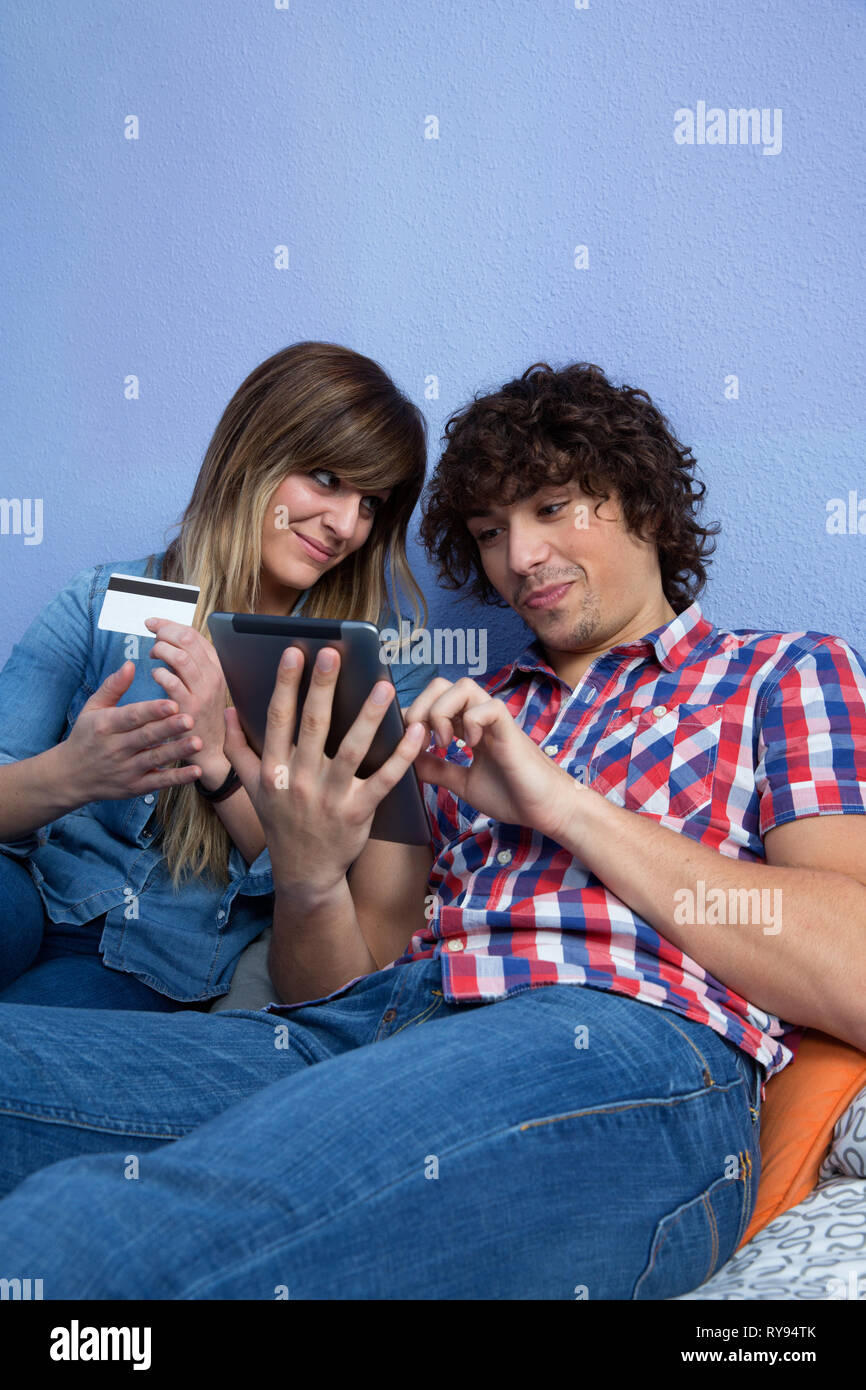 Woman convincing husband to make online purchase Stock Photo