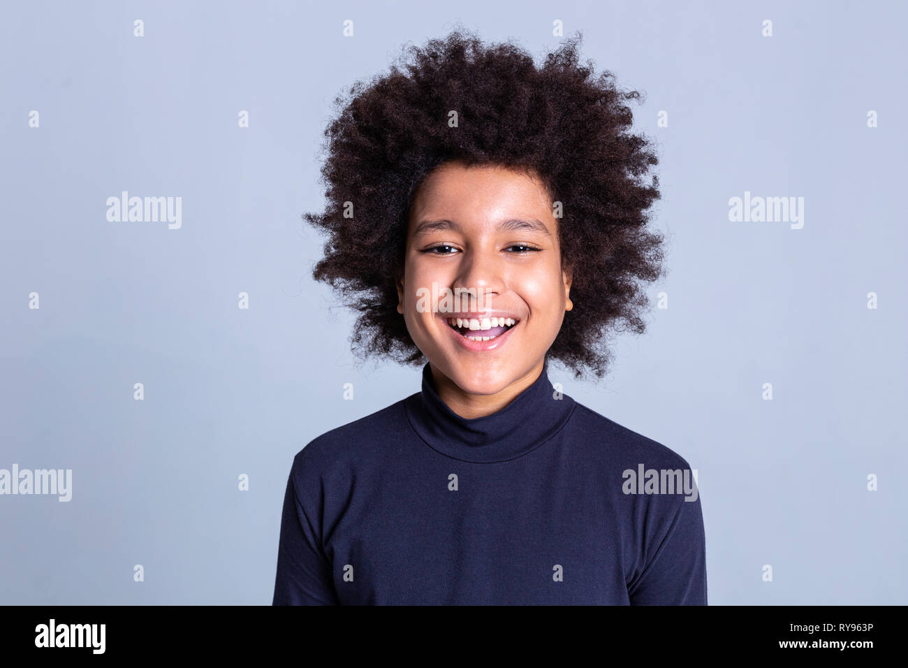 Dark-haired African American little person being extremely happy during photoshoot Stock Photo