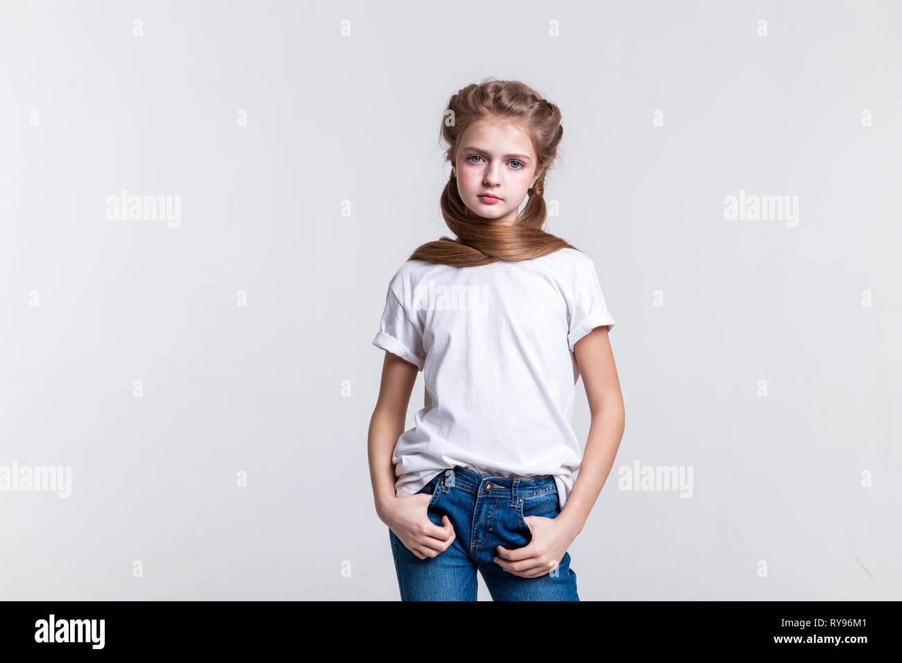 Calm long-haired pretty girl posing on camera Stock Photo