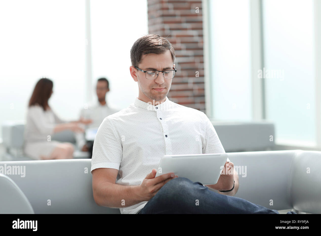 modern man uses a digital tablet for reading Stock Photo