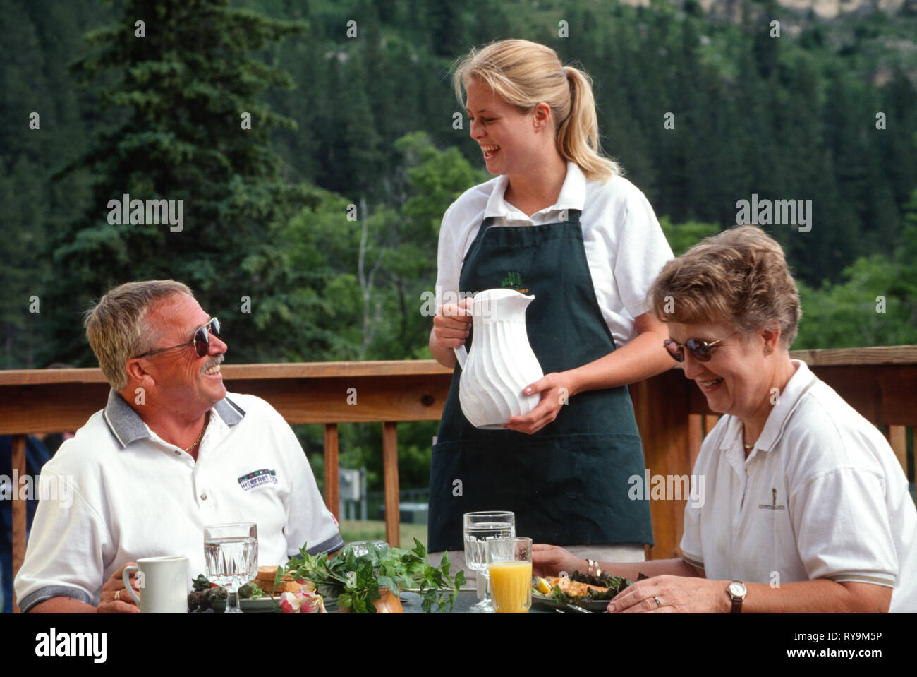 Young Waitress Delivers a Fried Fish and Eggs Breakfast Platter, spearfish Canyon, SD, USA Stock Photo