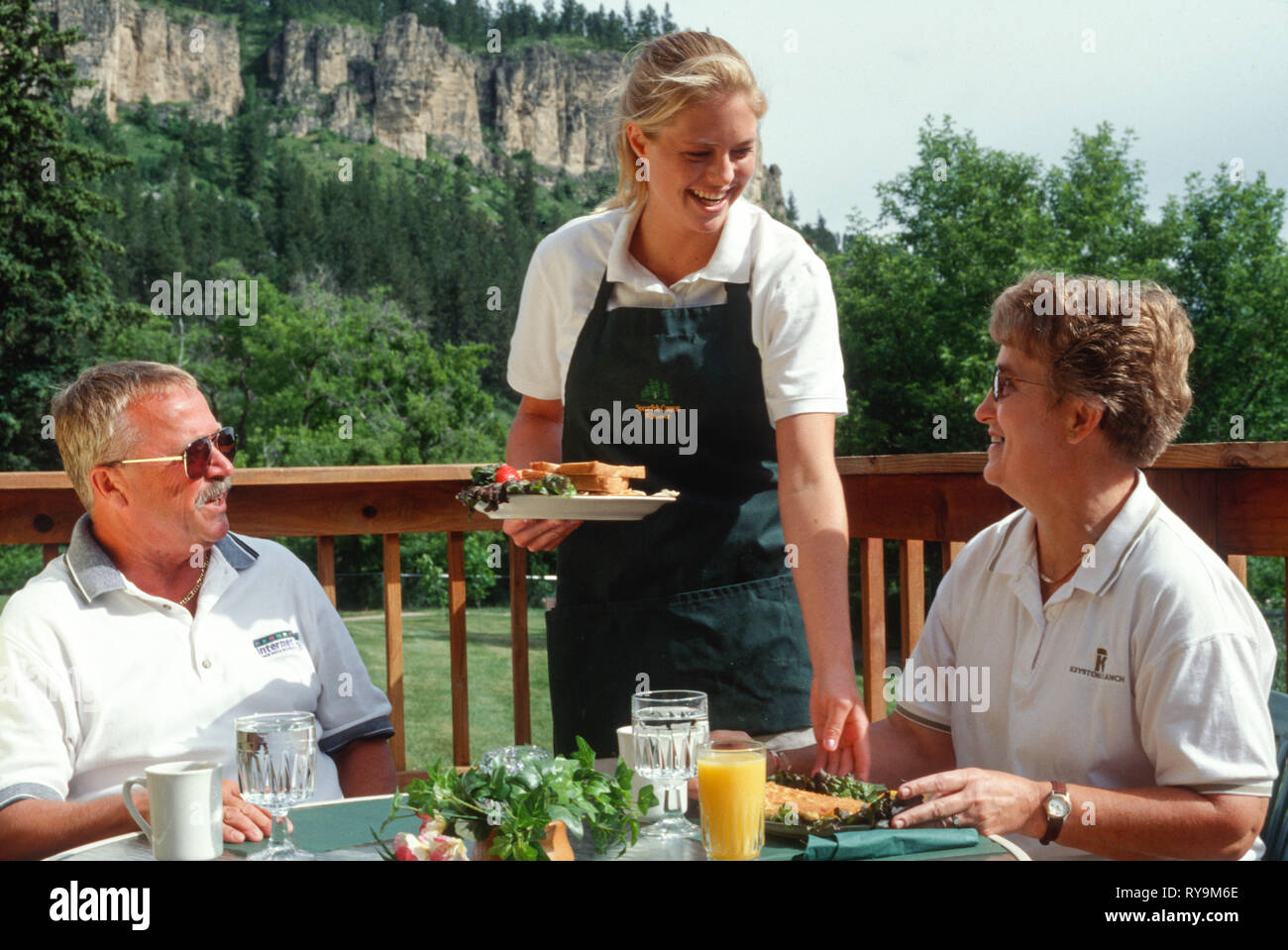 Young Waitress Delivers a Fried Fish and Eggs Breakfast Platter, spearfish Canyon, SD, USA Stock Photo