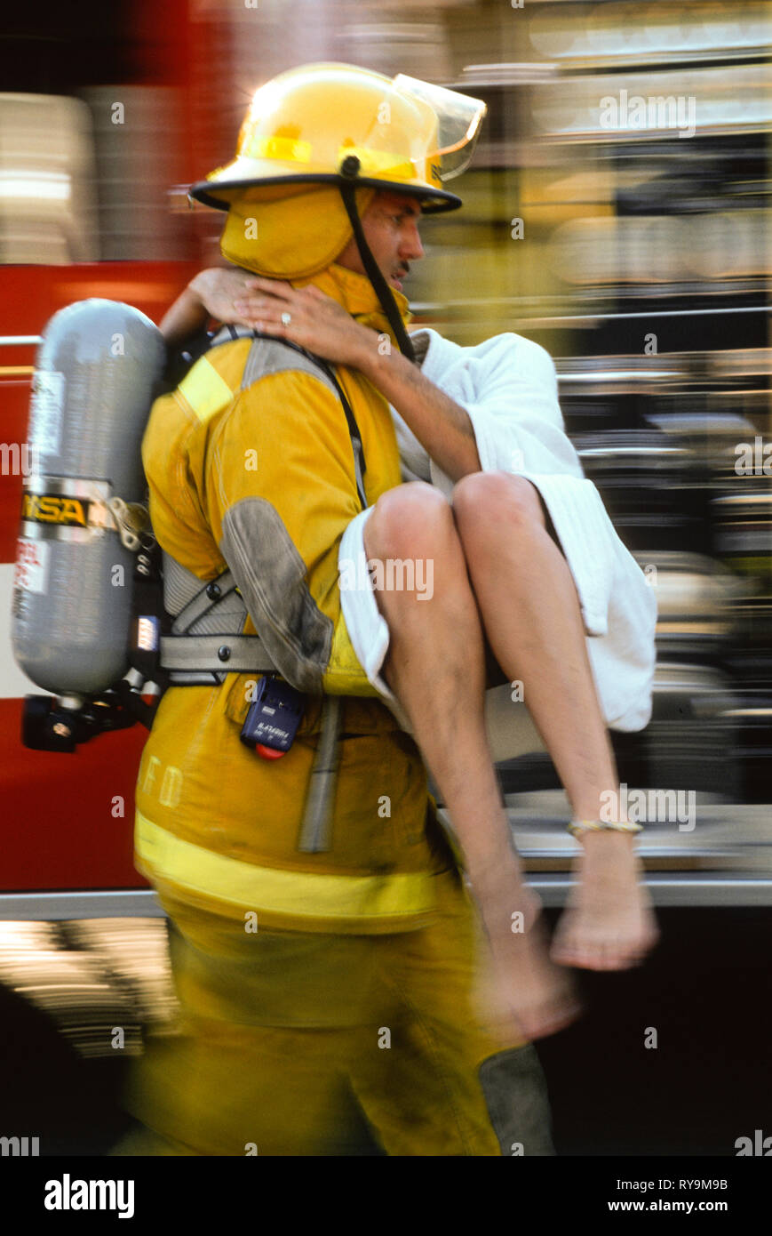 Firemen Rescuing Fireman Rescuing a Young Girl at a Fire Scene, USA 1997 Stock Photo - Alamy
