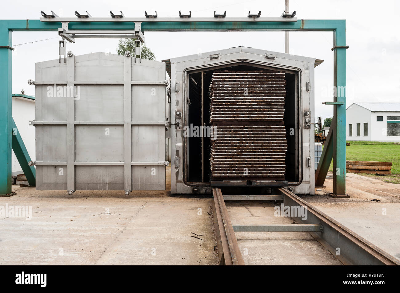 Lumber on conveyor belt in factory Stock Photo