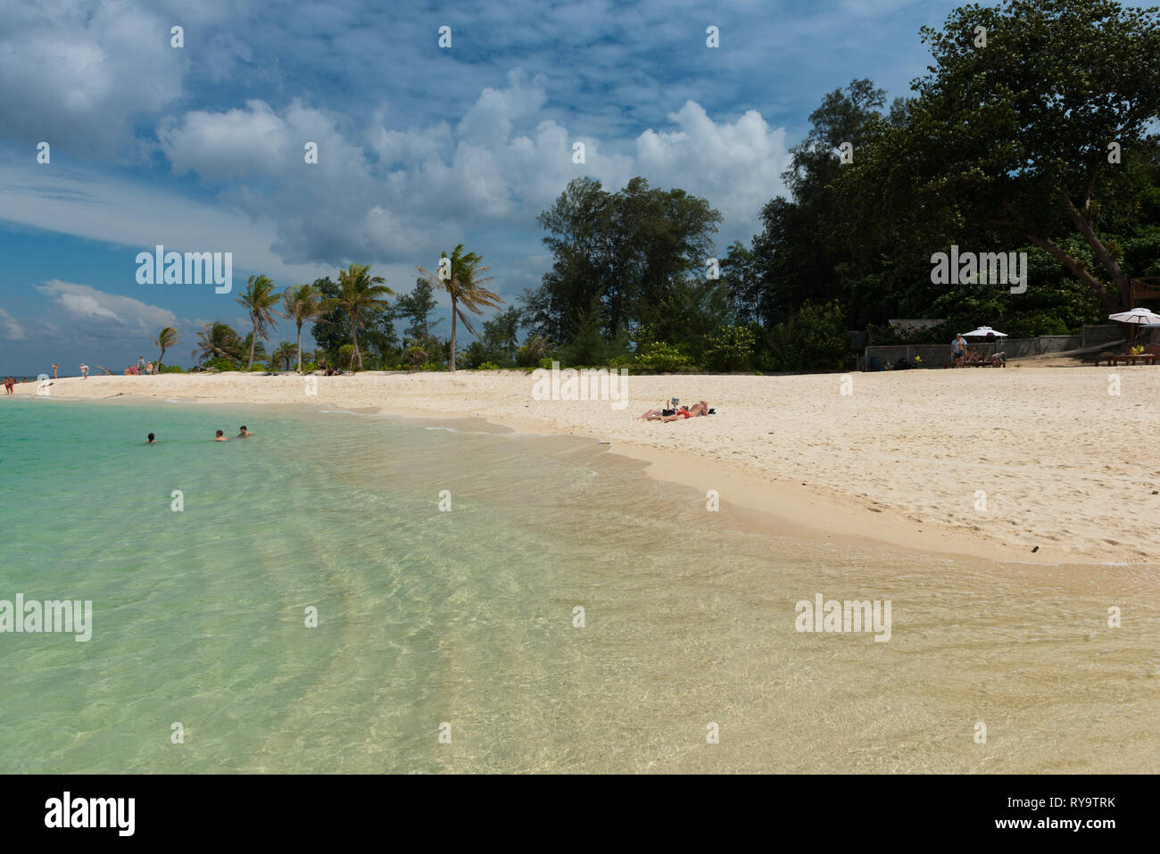 People sunbathing on Koh Lipe beautiful white sand beach, Thailand Stock Photo