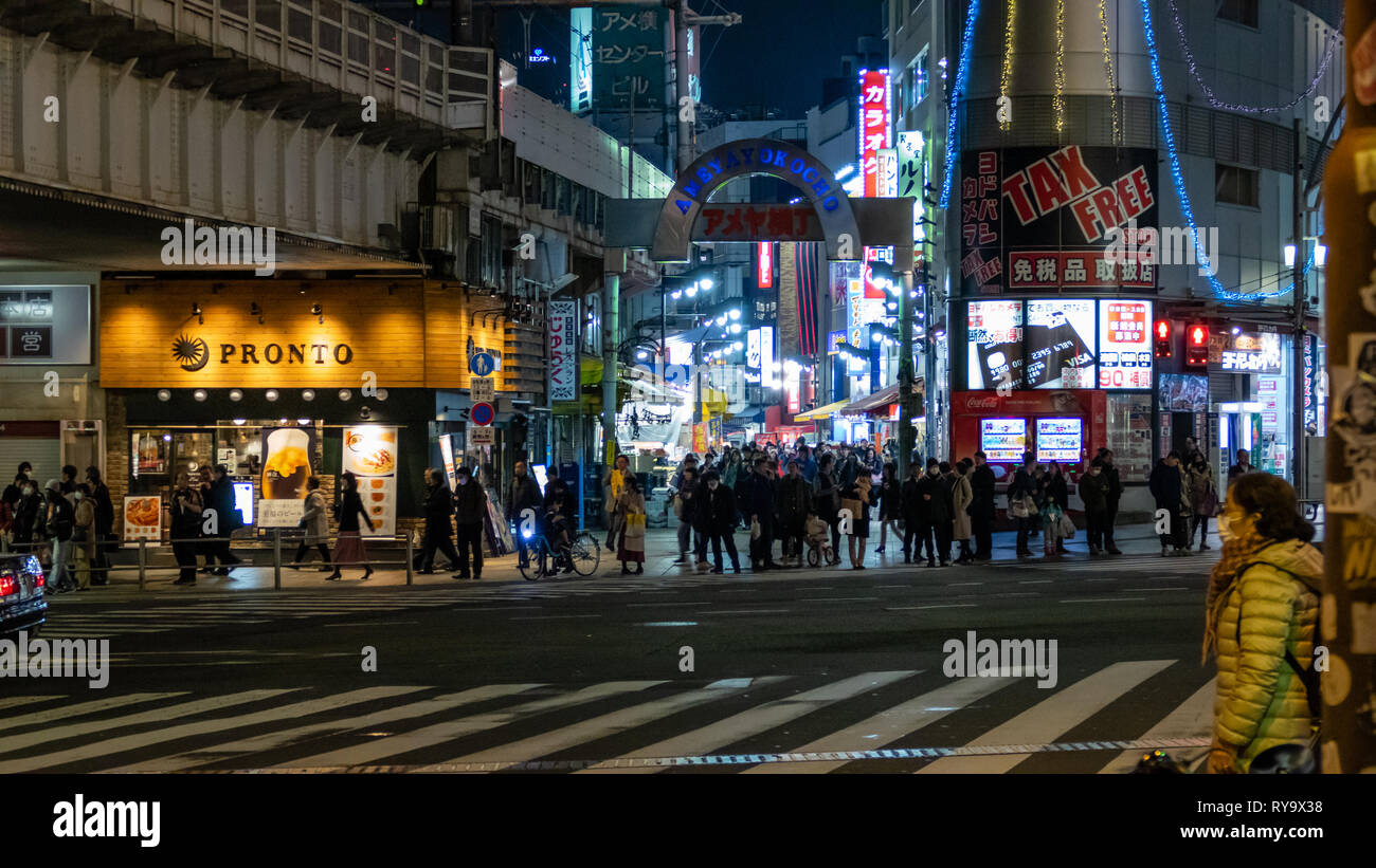 TOKYO, JAPAN - FEBRUARY 7, 2019: People in Ameyoko or Ameyayokocho market near Ueno station. A major shopping street in Tokyo. Japanese text advertise Stock Photo