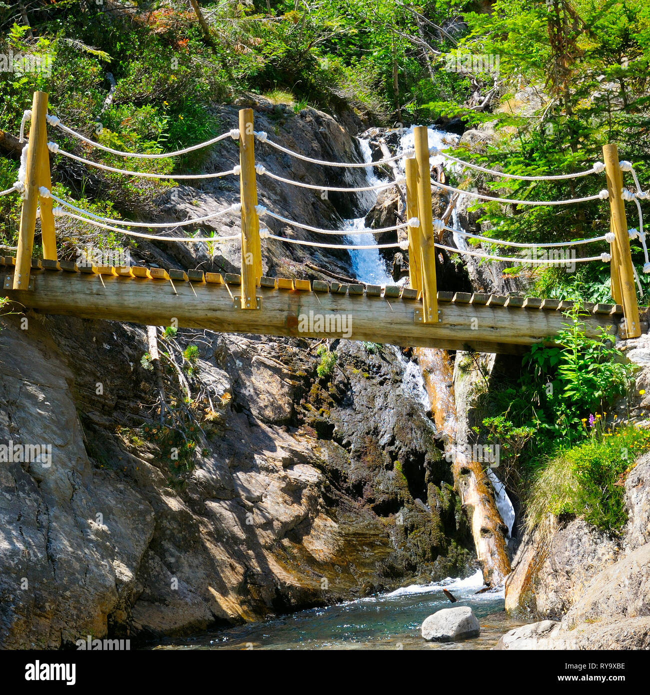 bridge over a mountain river and stony bank Stock Photo