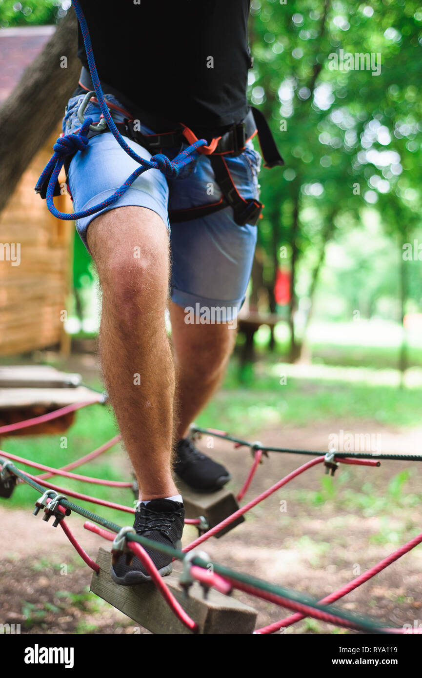 Hiking in the rope park beautiful sports guy Stock Photo Alamy