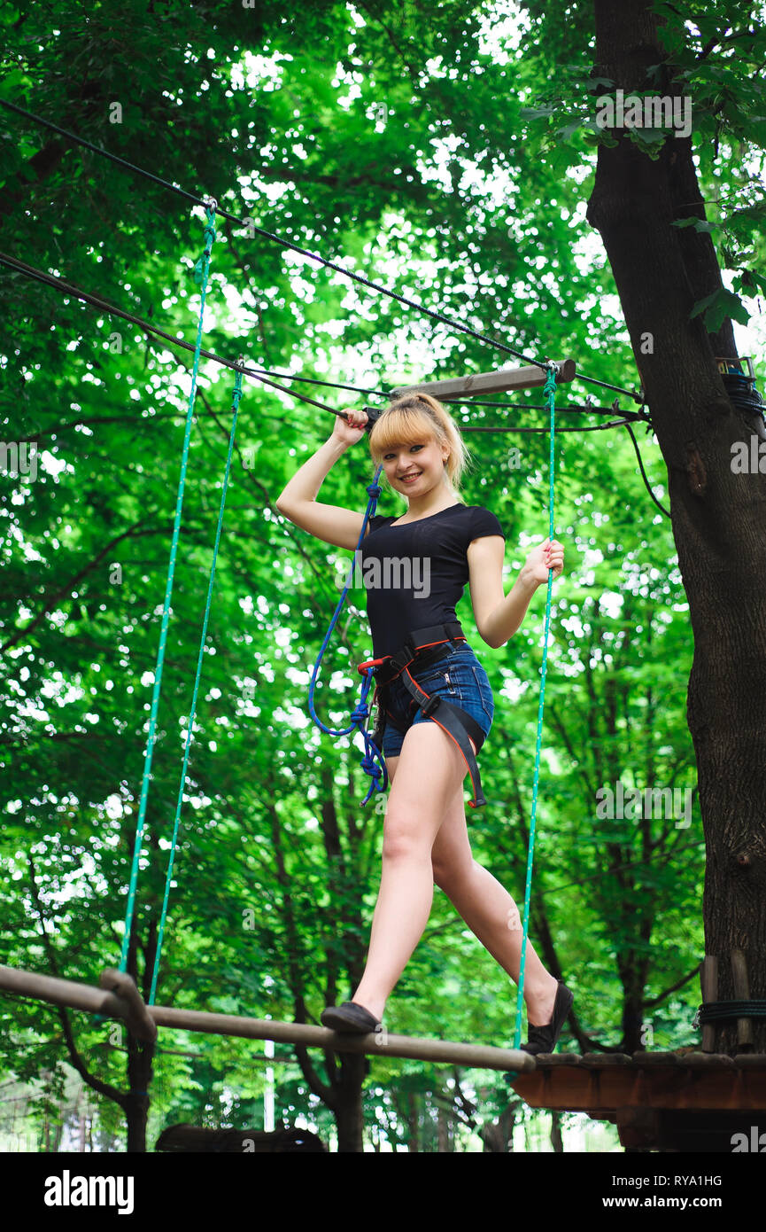 Hiking in the rope park beautiful sports girl Stock Photo Alamy