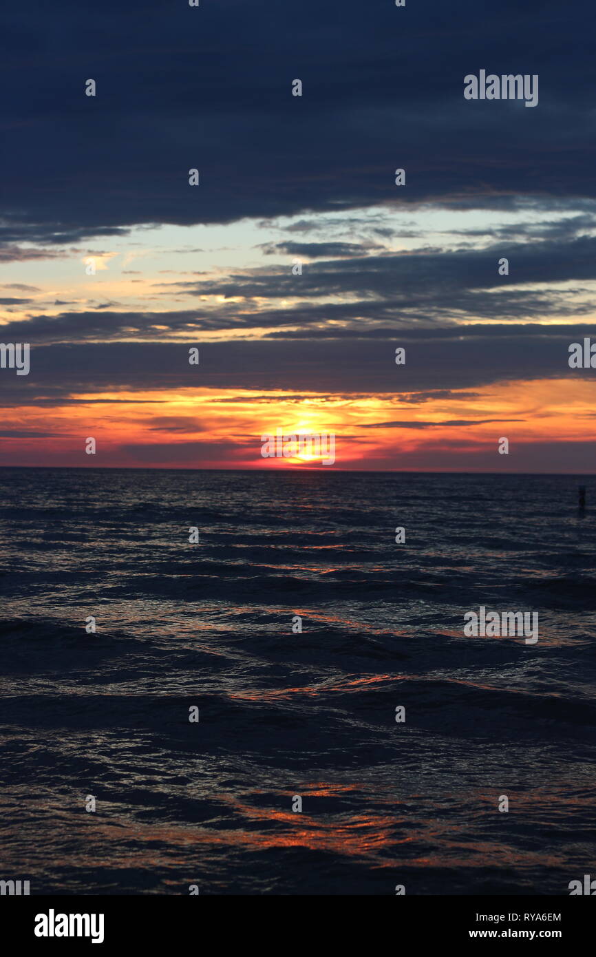 To feel the waves gently lapping at your toes as you walk along the beach, then to behold this beautiful sunset puts you in a place of calm. Stock Photo