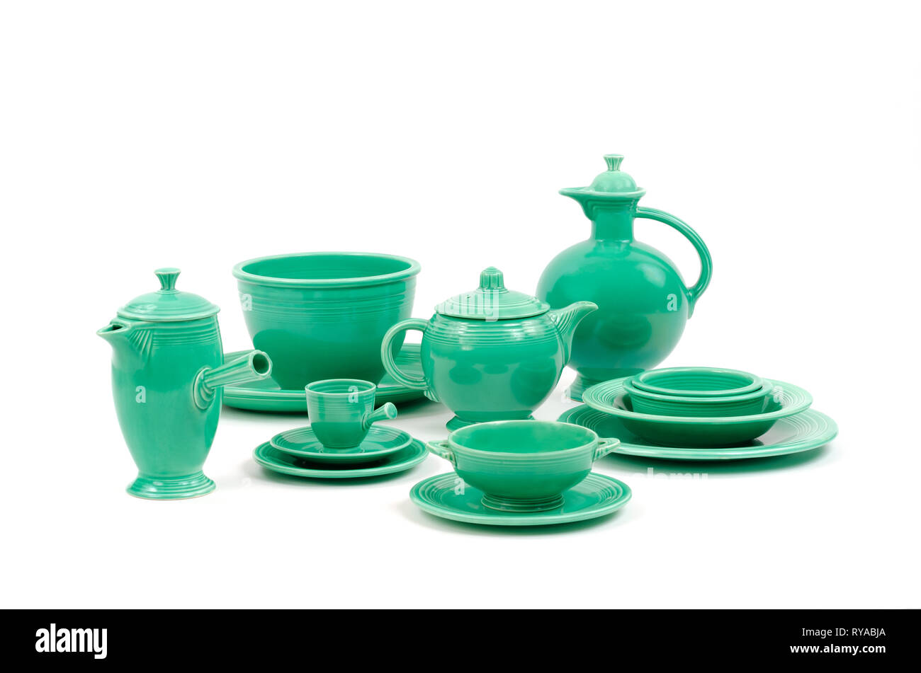 Original Green Glaze Vintage Antique Fiesta Ware Pottery and Tableware. Saucers, Plates, Demitasse Coffee Carafe and Cup, Bowl, Tea pot and Pitcher. Stock Photo