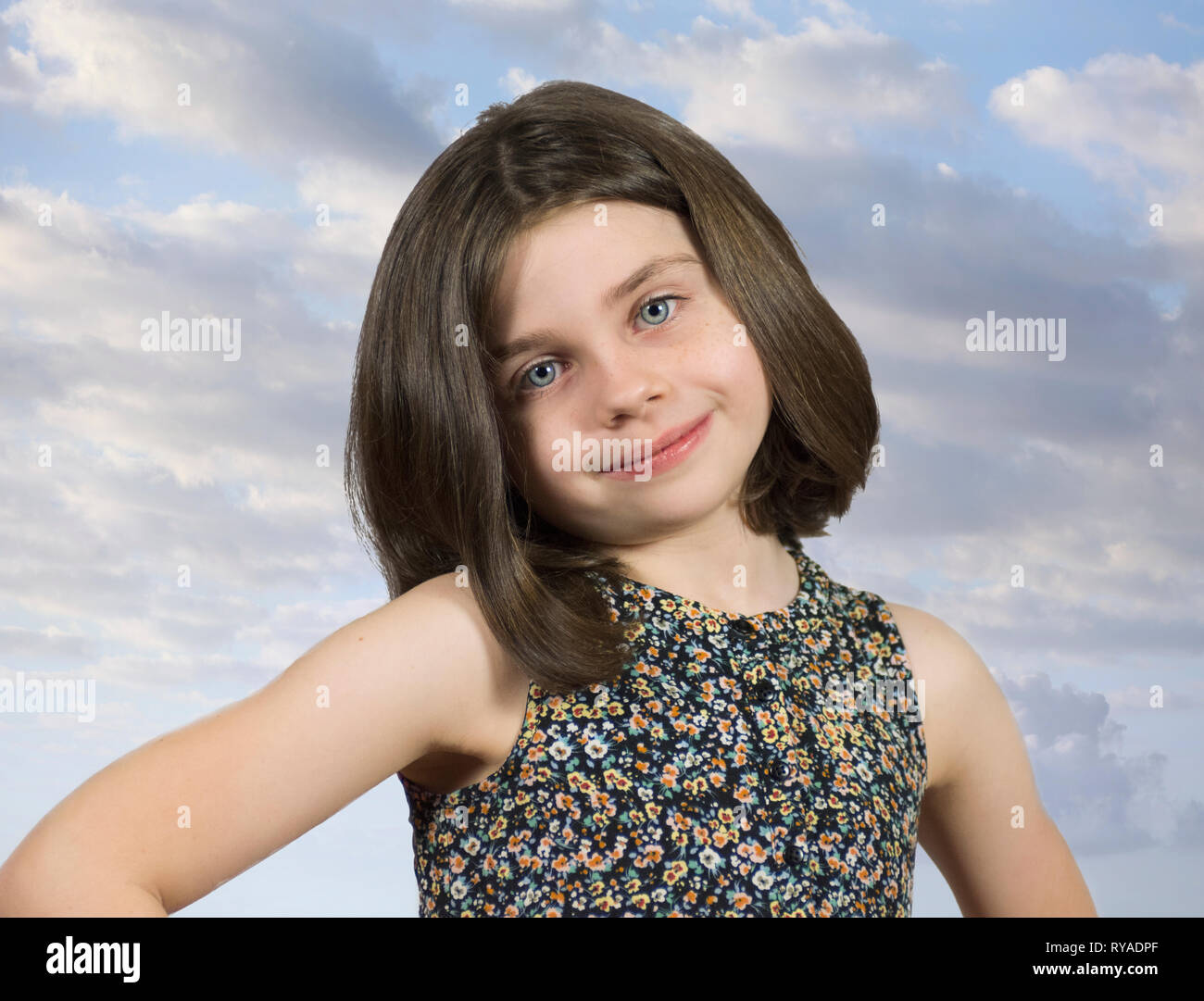 Young Girl With Short Hair Smiling With Clouds Behind Her Stock