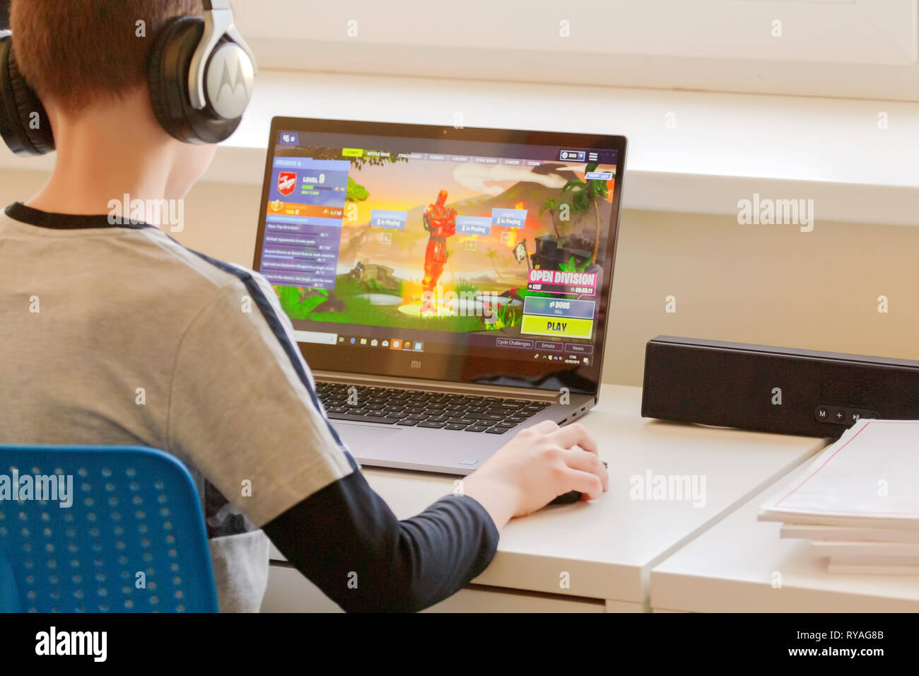 Child playing Fortnite game. Fortnite is popular online video game developed by Epic Games Stock Photo