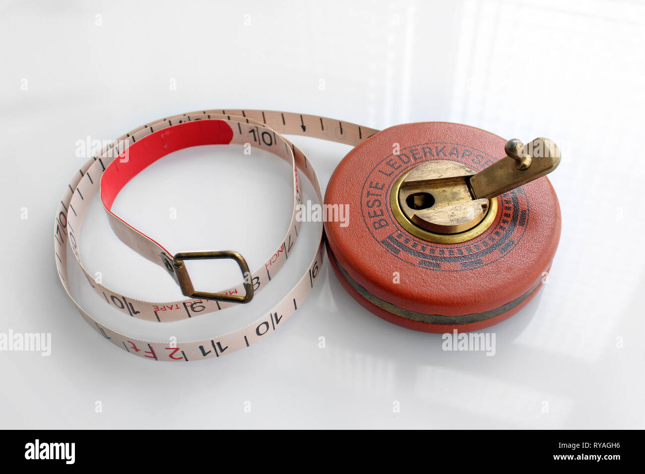 Old german roll measuring tape, isolated on white background, closeup