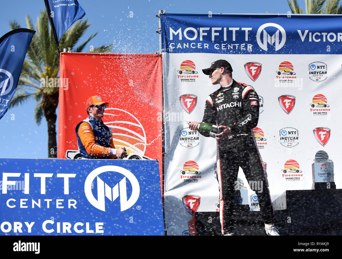 March 10, 2019 - St. Petersburg, Florida, United States - Team Penske driver Josef Newgarden of the United States (right), winner of the Firestone Grand Prix of St. Petersburg,  and Chip Ganassi Racing driver Scott Dixon of New Zealand, who finished second, spray each other with champagne on March 10, 2019 in St. Petersburg, Florida. (Paul Hennessy/Alamy) Stock Photo