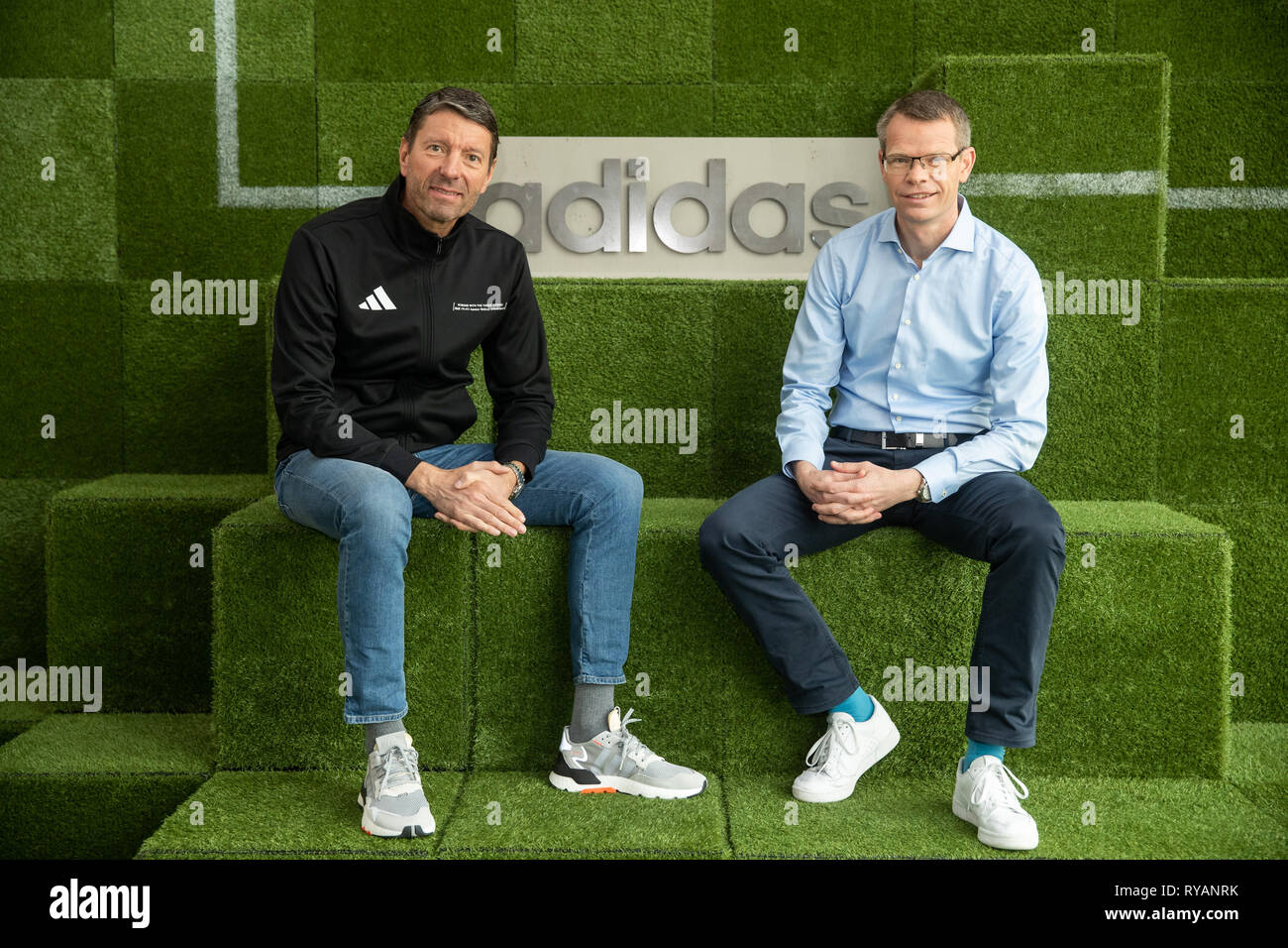 Herzogenaurach, Germany. 13th 2019. Kasper Rorsted (l), CEO of sports goods manufacturer adidas AG, and Harm Ohlmeyer, CFO of adidas AG, will sit next to the company logo before the start