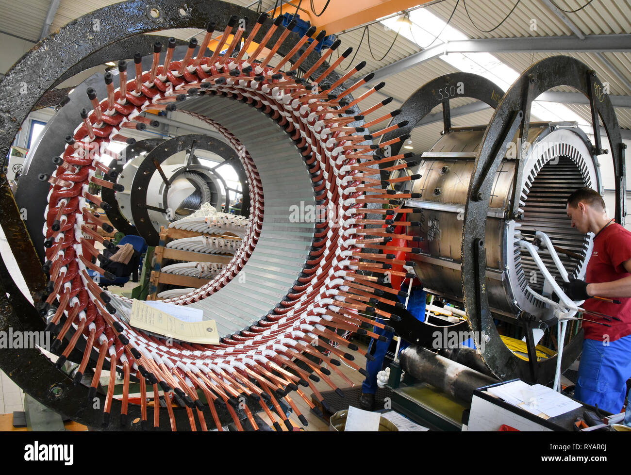 Bitterfeld Wolfen, Germany. 11th Mar, 2019. At Pamo Reparaturwerk GmbH, a company of the Partzsch Döbeln Group, an employee works on stators for electric motors and generators. The parts weighing several tons for electrically rotating machines with an output of 100 kilowatts to 250,000 kilovolt amperes are used worldwide in steel mills, power stations, sugar factories and in engine and generator end manufacturers. The company specializes primarily in the repair, maintenance and new manufacture of electrical machines. Credit: Waltraud Grubitzsch/dpa-Zentralbild/ZB/dpa/Alamy Live News Stock Photo