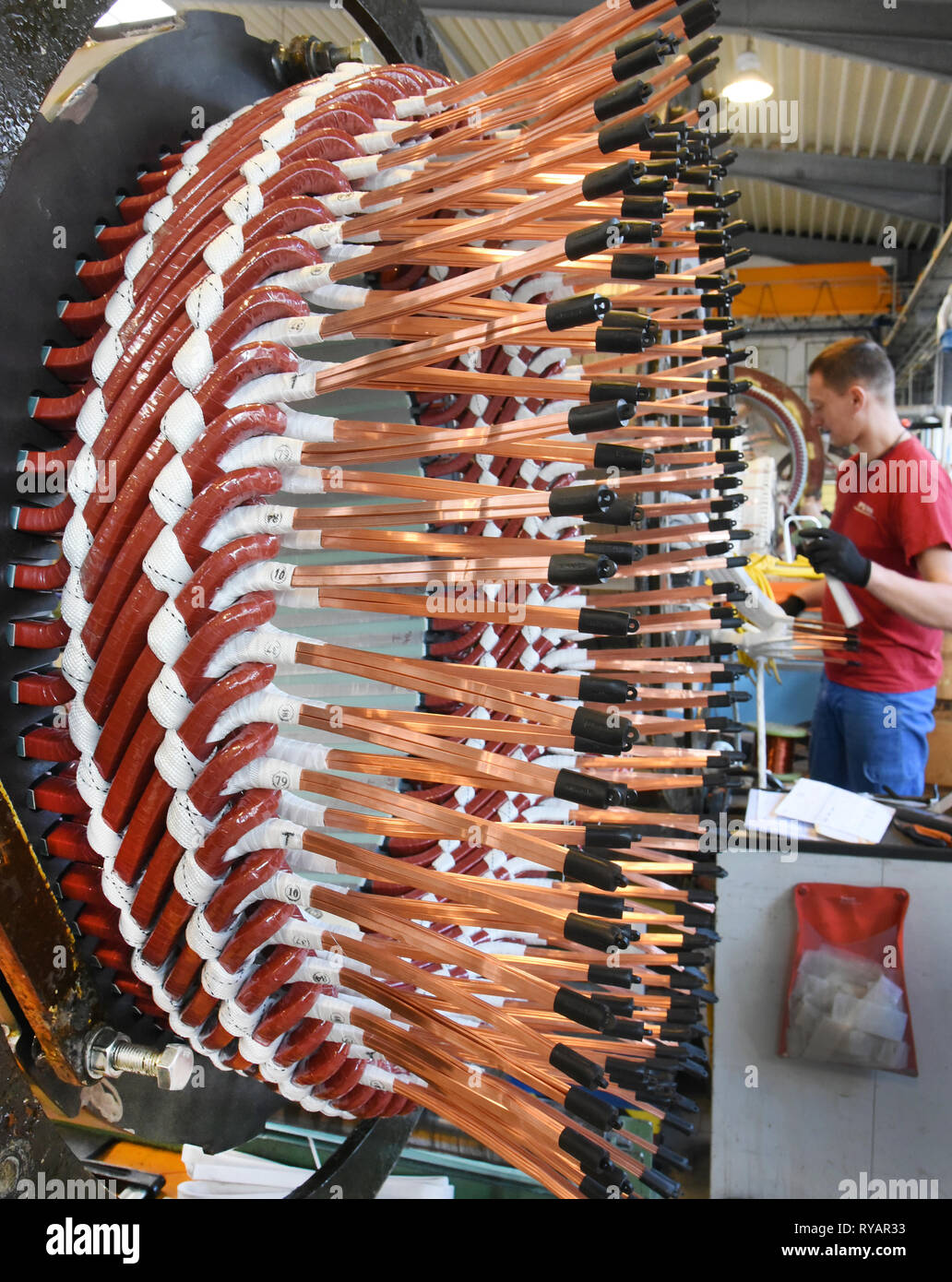 Bitterfeld Wolfen, Germany. 11th Mar, 2019. At Pamo Reparaturwerk GmbH, a company of the Partzsch Döbeln Group, an employee works on stators for electric motors and generators. The parts weighing several tons for electrically rotating machines with an output of 100 kilowatts to 250,000 kilovolt amperes are used worldwide in steel mills, power stations, sugar factories and in engine and generator end manufacturers. The company specializes primarily in the repair, maintenance and new manufacture of electrical machines. Credit: Waltraud Grubitzsch/dpa-Zentralbild/ZB/dpa/Alamy Live News Stock Photo
