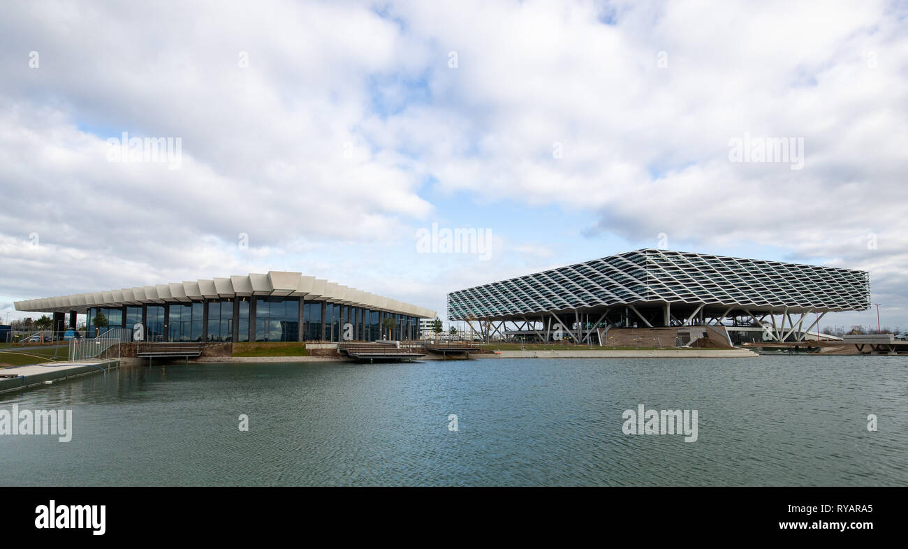 13 March 2019, Bavaria, Herzogenaurach: The administration building "Arena"  (r) and the event building with the canteen "Halftime" at the headquarters  of the sporting goods manufacturer adidas AG. The "Arena" building will