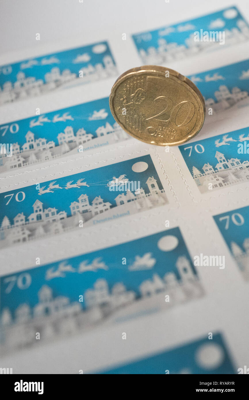 Berlin, Germany. 13th Mar, 2019. There's a 20-cent coin on some 70-cent stamps. The federal government has set the course for a significant increase in letter postage. According to industry circles, the postage for a standard letter could rise from currently 70 cents to 85 to 90 cents. Credit: Jörg Carstensen/dpa/Alamy Live News Stock Photo