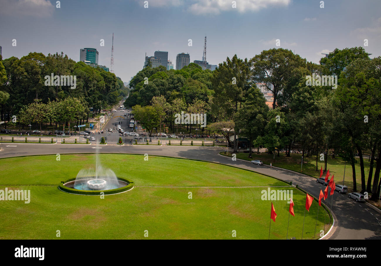 District 1,  Ho Chi Minh City, Vietnam, Wednesday 13th March 2019.  Saigon weather::Hot spring day with highs of 36 degrees. . View of gardens and skyline from Reunification Palace which was the base of  Vietnamese General Ngo Dinh Diem until his death in 1963. It made its name in global history in 1975. A tank belonging to the North Vietnamese Army crashed through its main gate, ending the Vietnam War. Credit: WansfordPhoto/Alamy Live News Stock Photo